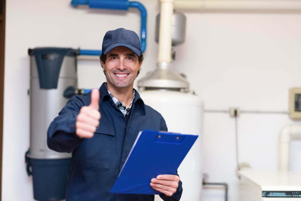 Man Holding a Clipboard and Giving a Thumbs Up — Professional Plumber in Toowoomba