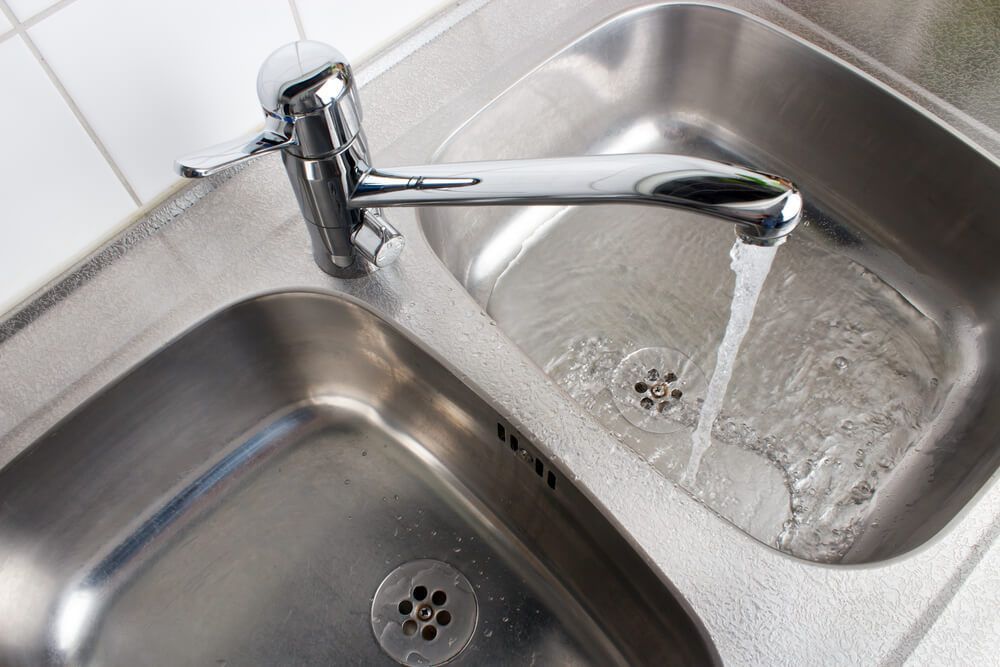 Stainless Steel Kitchen Sink with Water Running from The Faucet — Professional Plumber in Toowoomba 