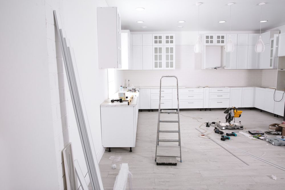 A Kitchen Under Construction with Cabinets Installed — Professional Plumber in Toowoomba