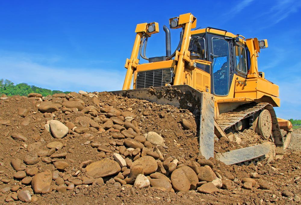The bulldozer on a building site collecting debris during excavation works — Stan Davies Excavations in Glendale, NSW