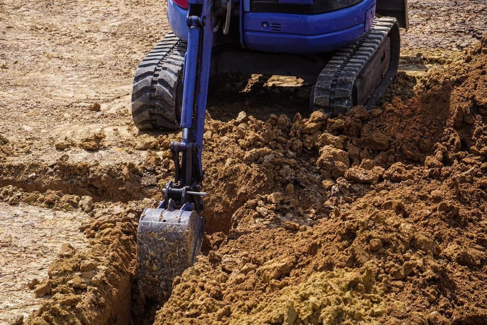 Mini excavator actively digging at the residence, providing efficient excavation services — Stan Davies Excavations in Glendale, NSW