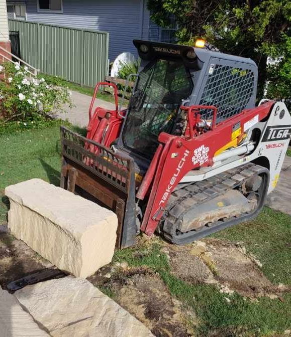Excavator Lifting Cement Block — Stan Davies Excavations in Glendale, NSW