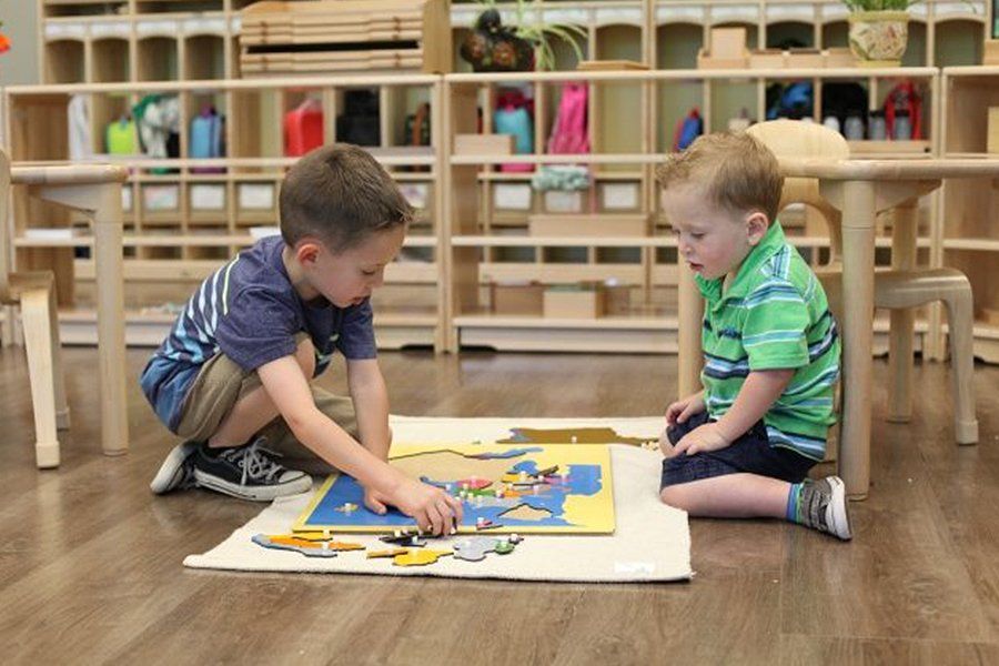 Children working with a world map puzzle