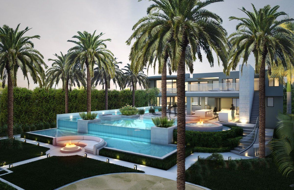 A large house with a swimming pool surrounded by palm trees ARCWERKS