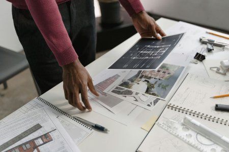 A person is holding a piece of paper on a table.