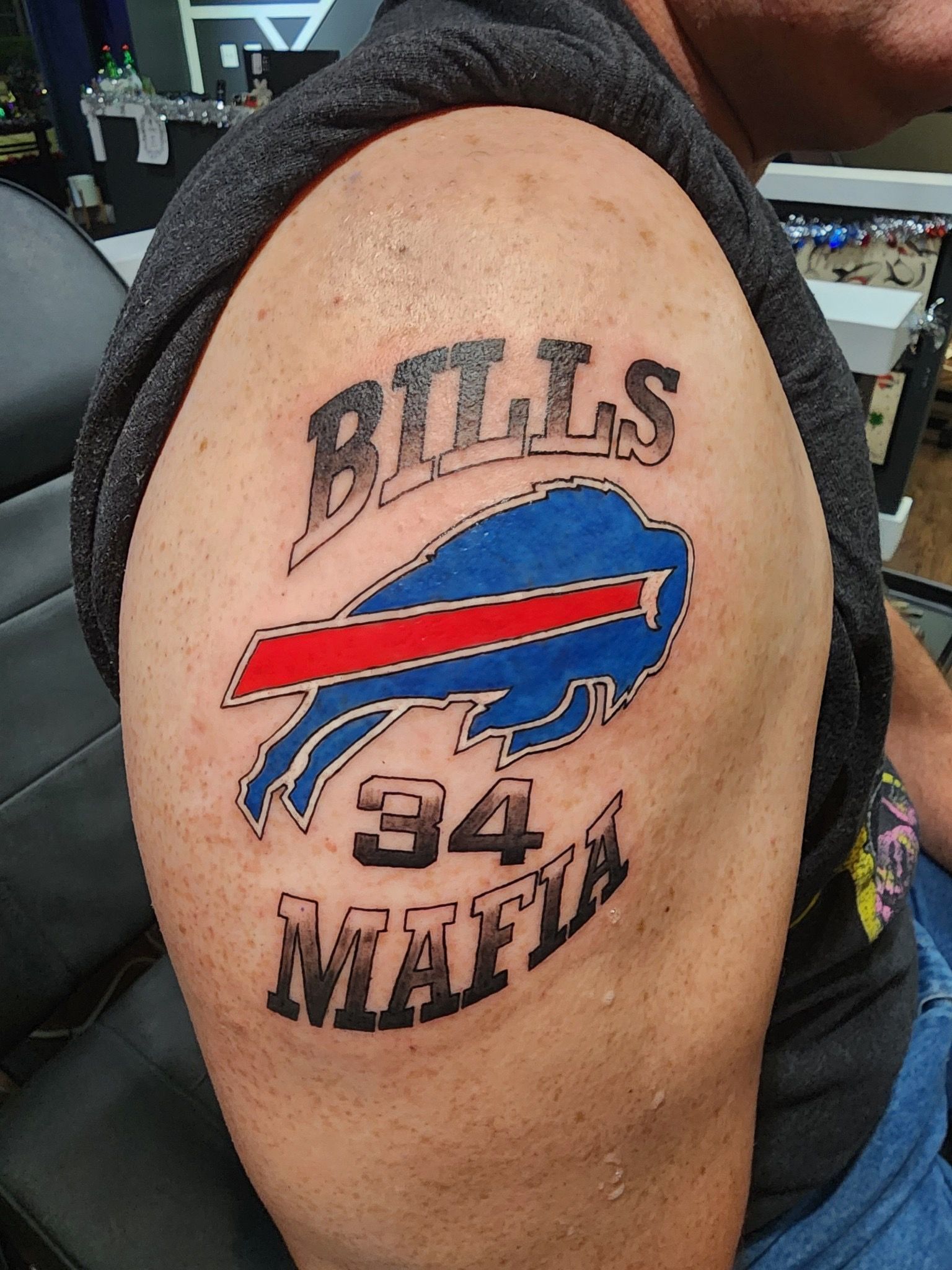 Buffalo Bills tattoo with logo and “Bills Mafia” on upper arm