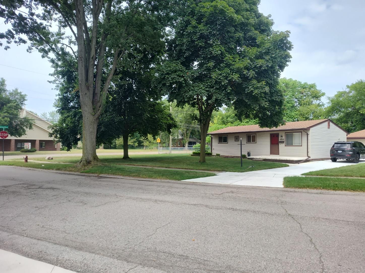 A house with a car parked in front of it