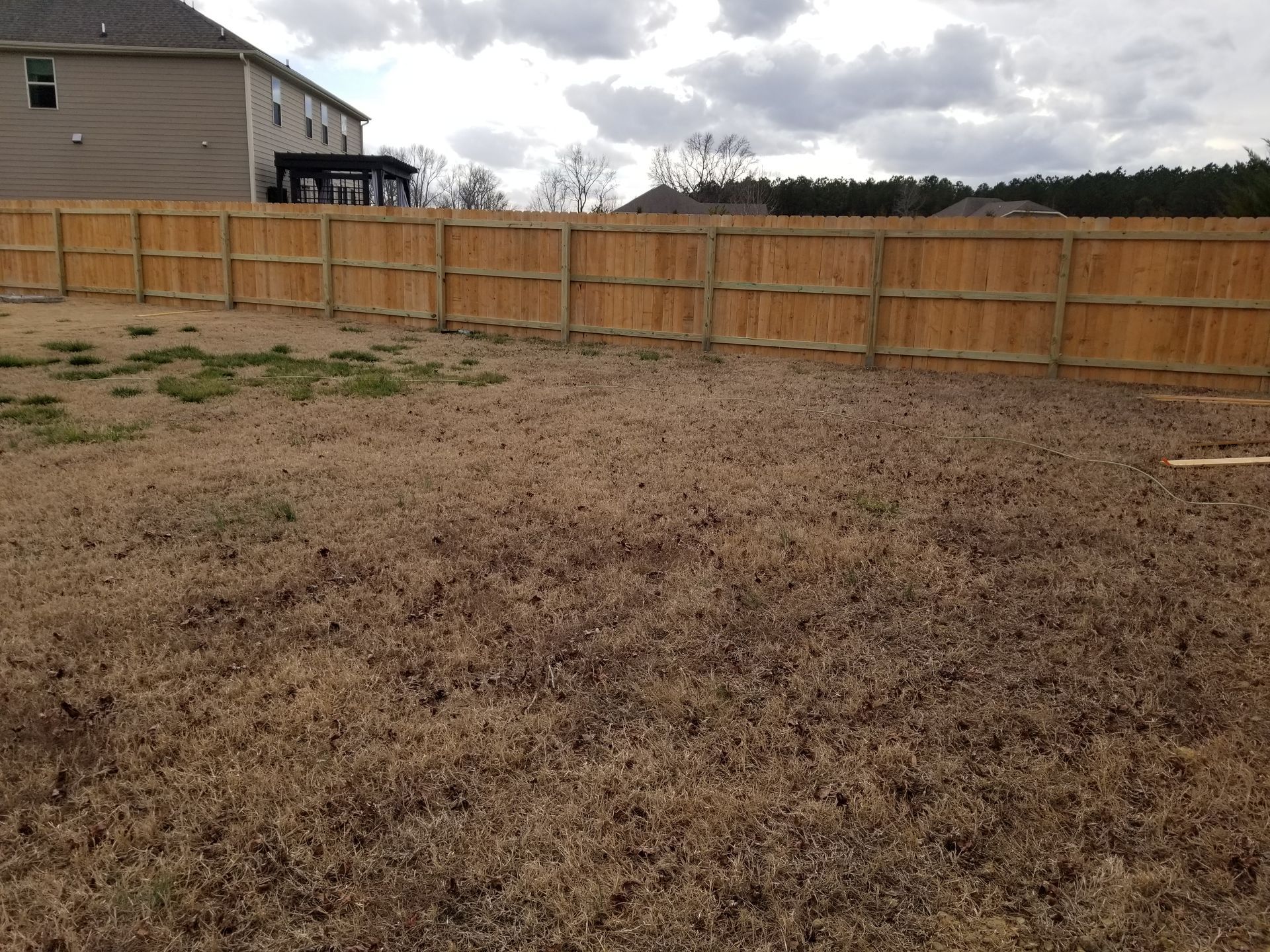 a yellow house with yellow fence