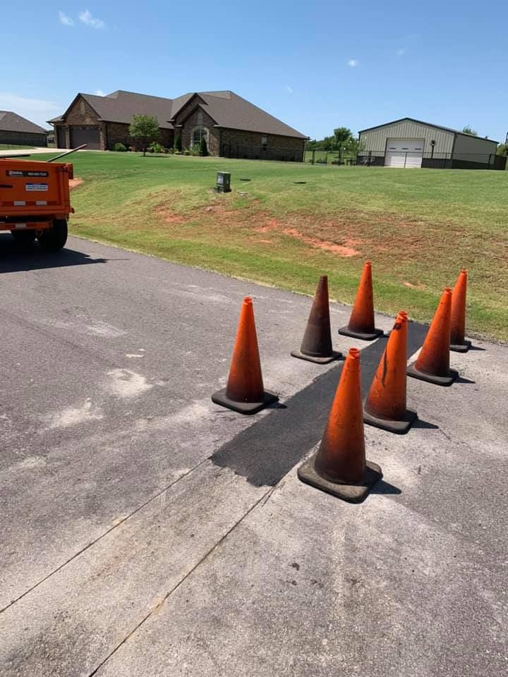A row of orange traffic cones on the side of a road