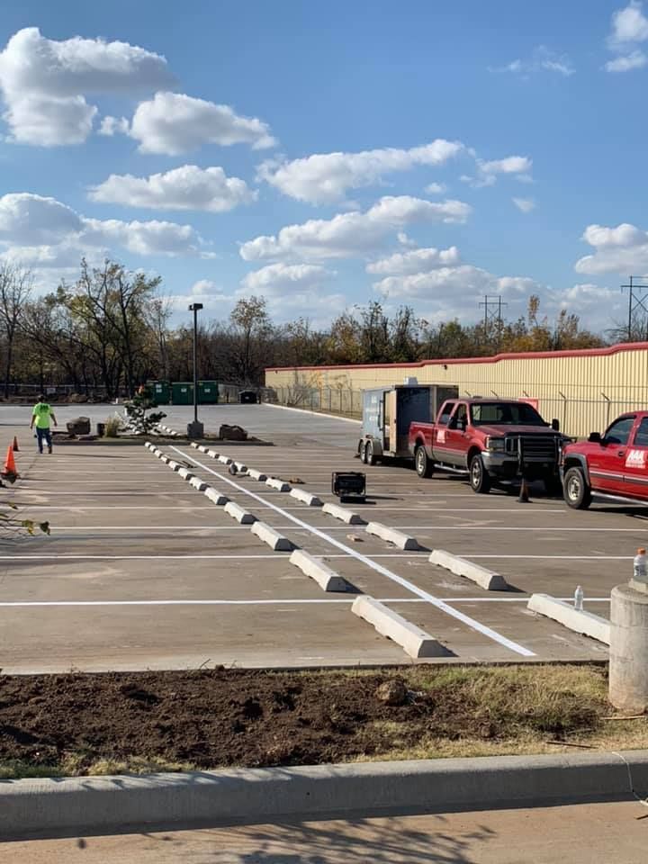 A row of red trucks are parked in a parking lot.