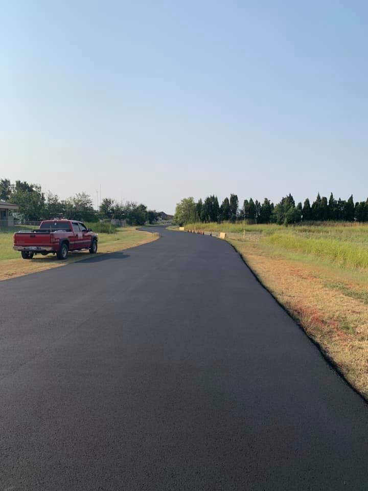 A red truck is parked on the side of a road.