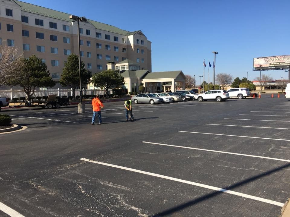 A parking lot with a large building in the background
