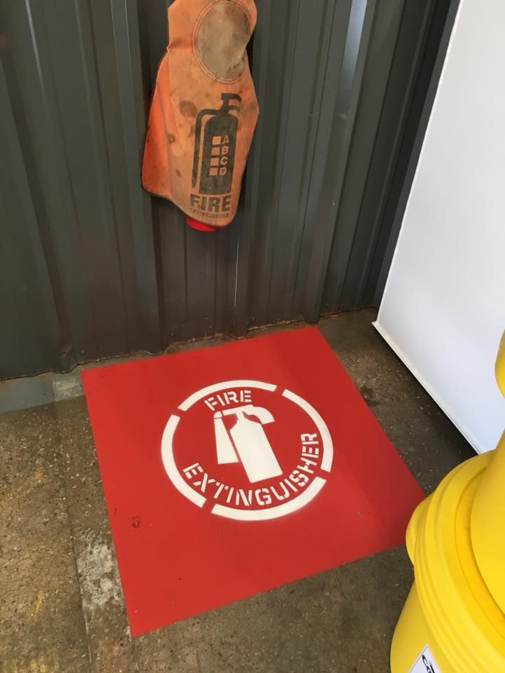 A red mat that says fire extinguisher on it