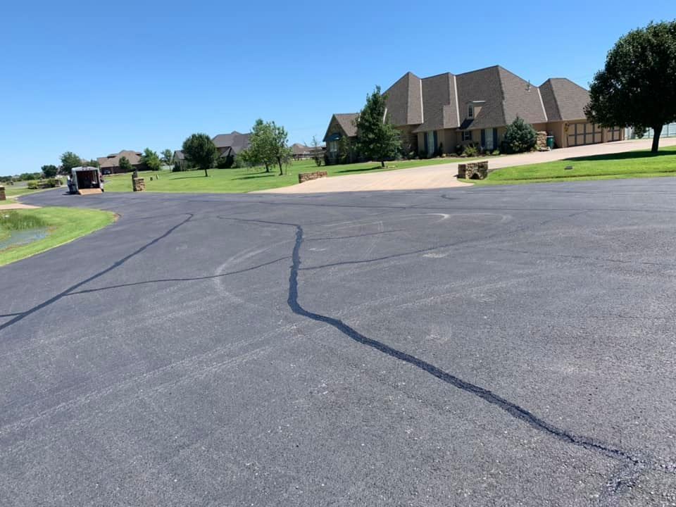 A driveway with a large house in the background