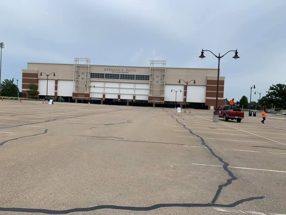 An empty parking lot in front of a large building