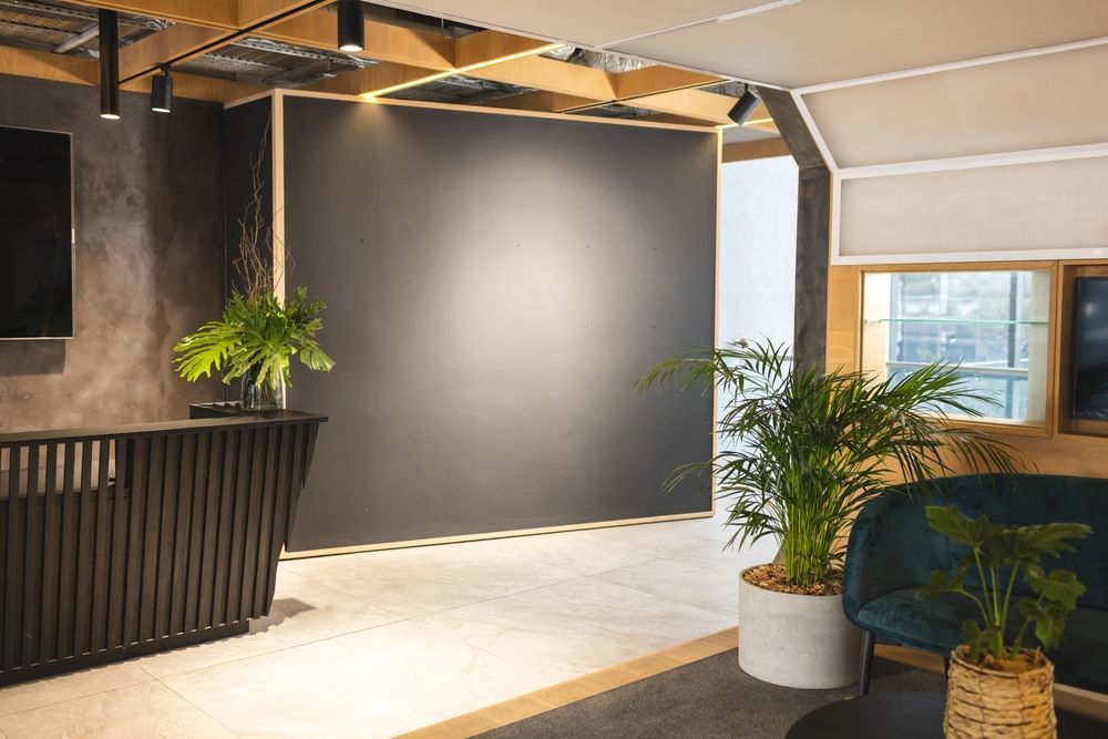 A living room with a couch , table , and plants.