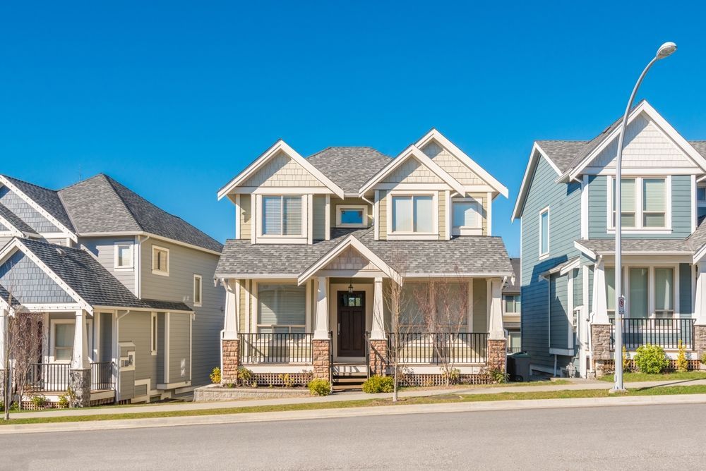A row of houses in a residential neighborhood on a sunny day.