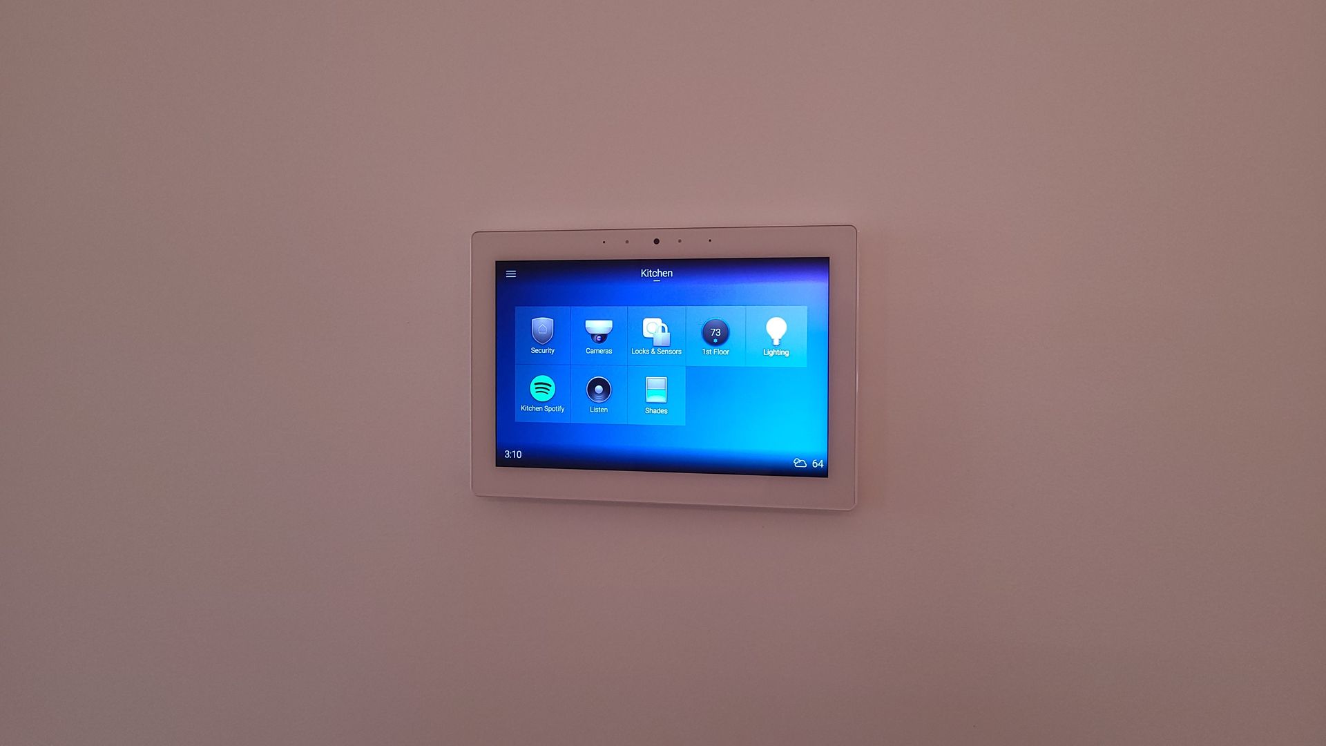 White tablet displaying blue screen, mounted on a plain white wall.