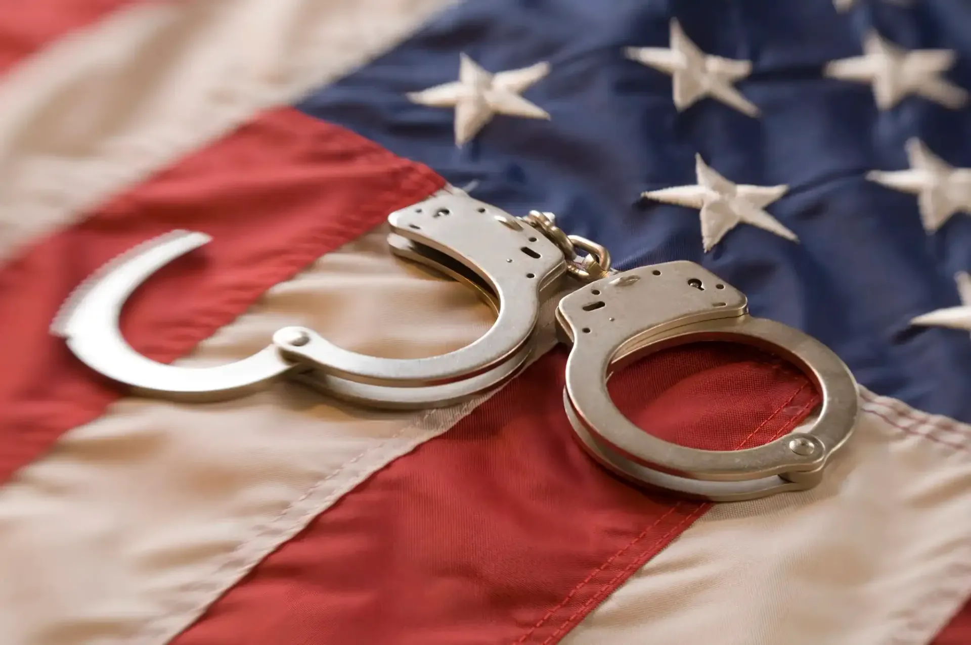 Handcuffs on a U.S. flag, symbolizing arrest or justice
