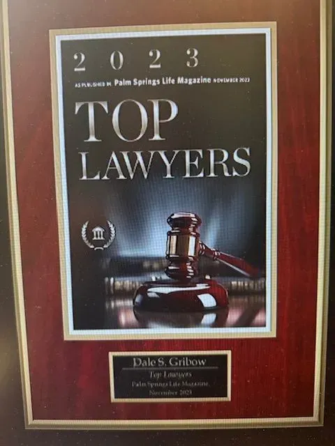 Framed 2023 Top Lawyers award plaque with a judge’s gavel on a red background