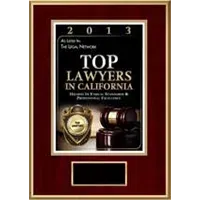 Framed award plaque for “Top Lawyers in California” with gold seal and gavel on a dark red background