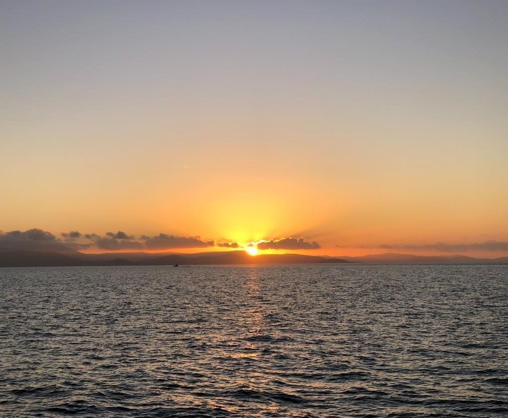 A Sunset Over a Large Body of Water — Whitsunday Fishing Charters In Airlie Beach, QLD