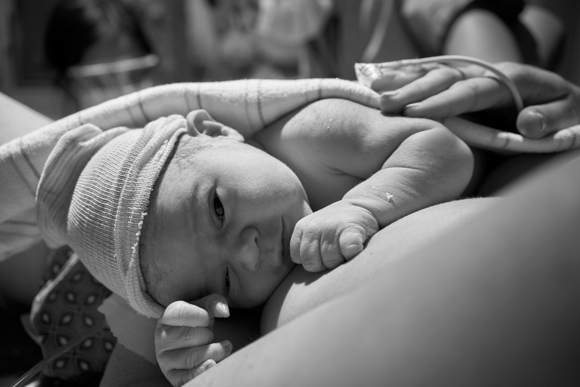 Newborn baby laying on mother's chest