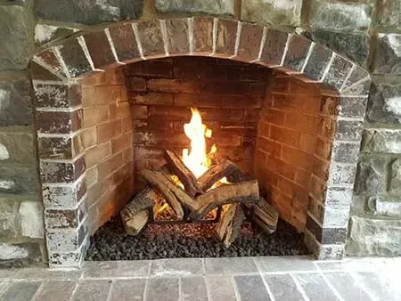 Cozy fireplace with a vibrant flame.