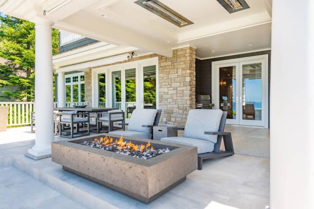 There is a fire pit on the patio of a house.