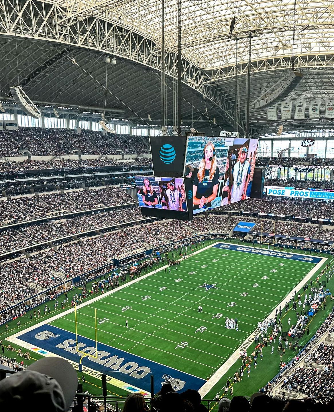 The AT&T stadium in Arlington, Tx filled with people watching a football game.