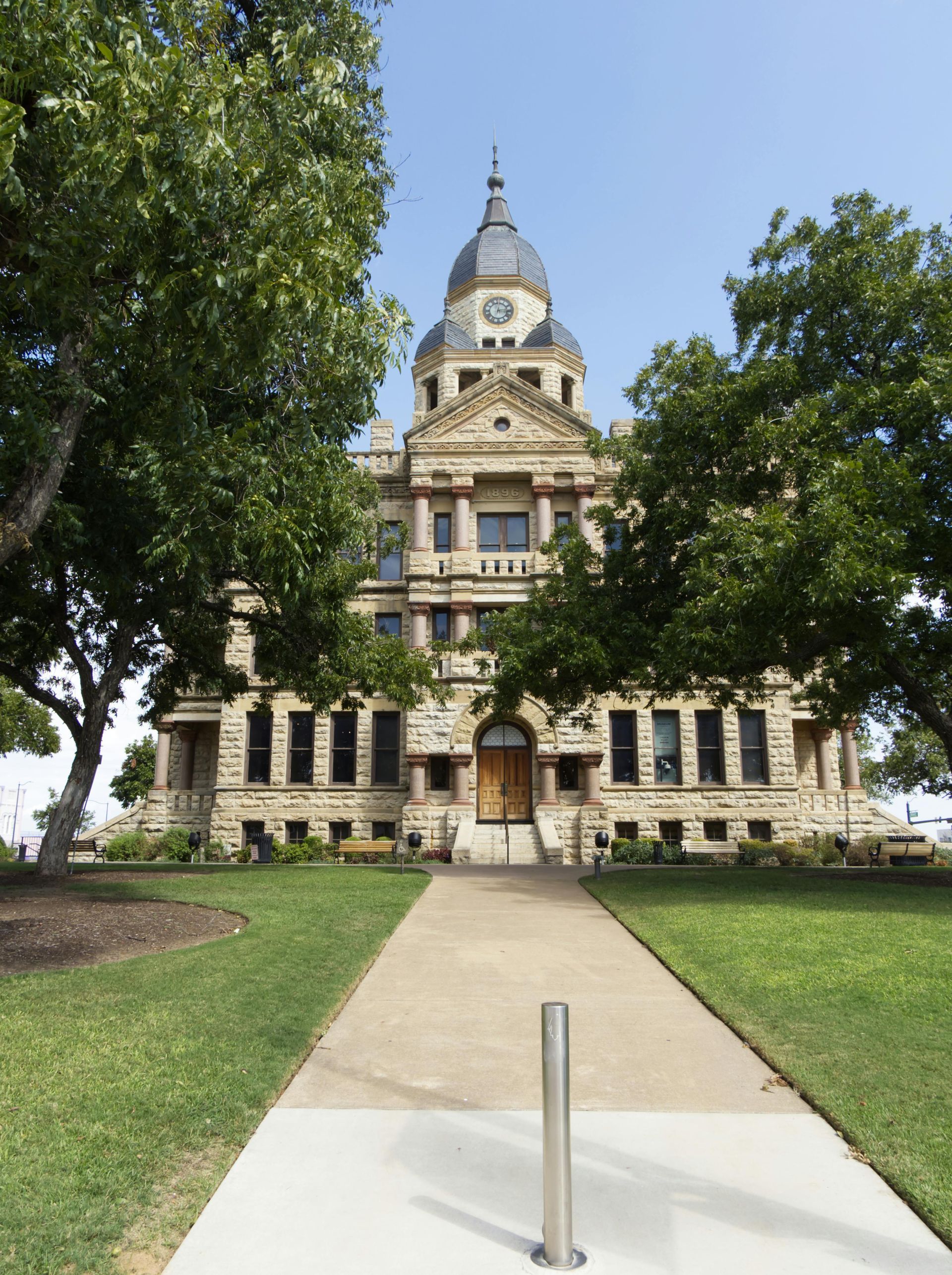 A large building with a clock on top of it in Waco, Tx