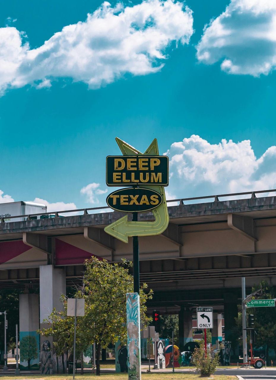 A sign in Dallas, Tx that says deep ellum texas on it