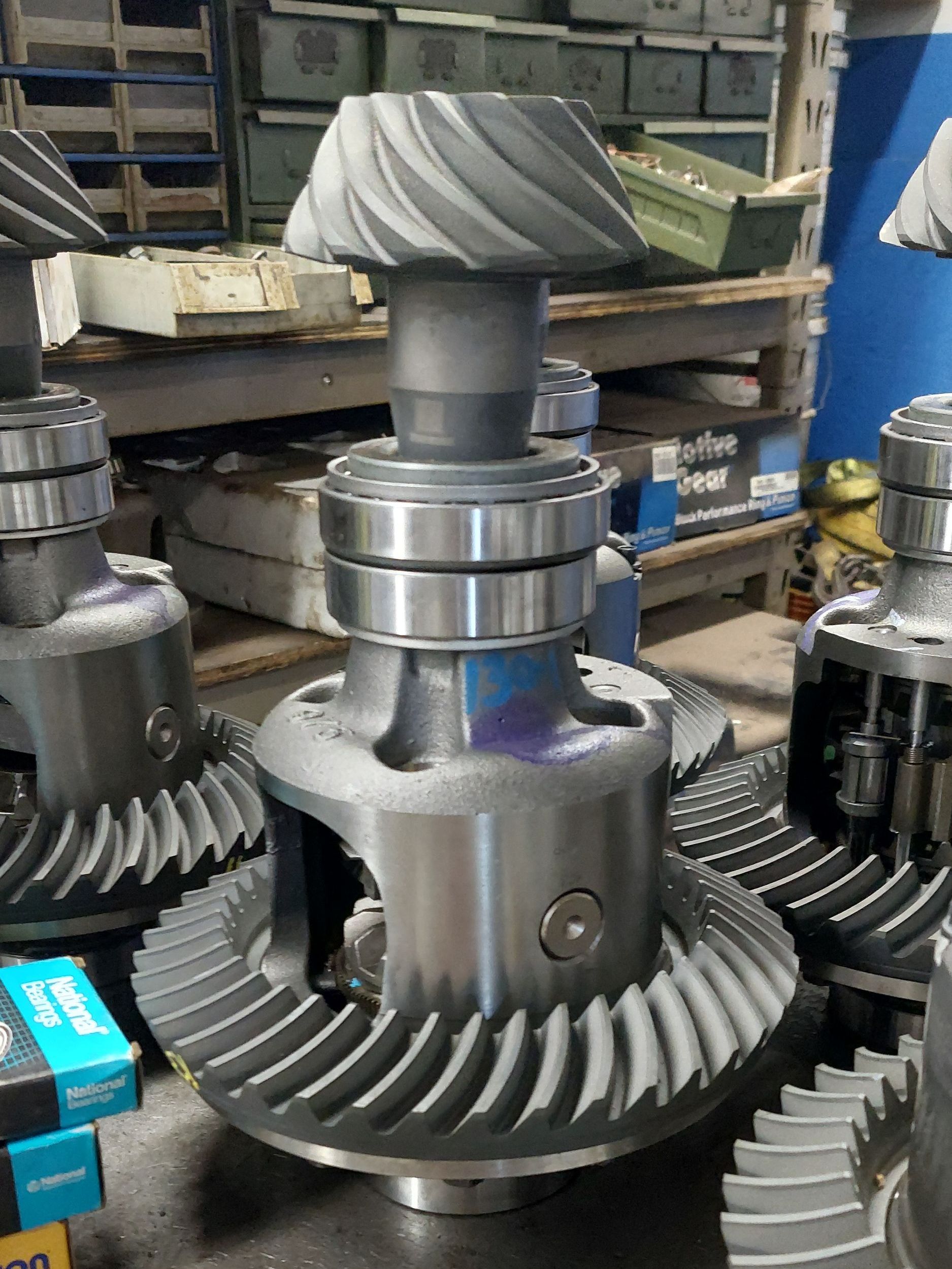 A group of drive shafts are sitting on top of a white table. A group of drive shafts are sitting on top of a white table.