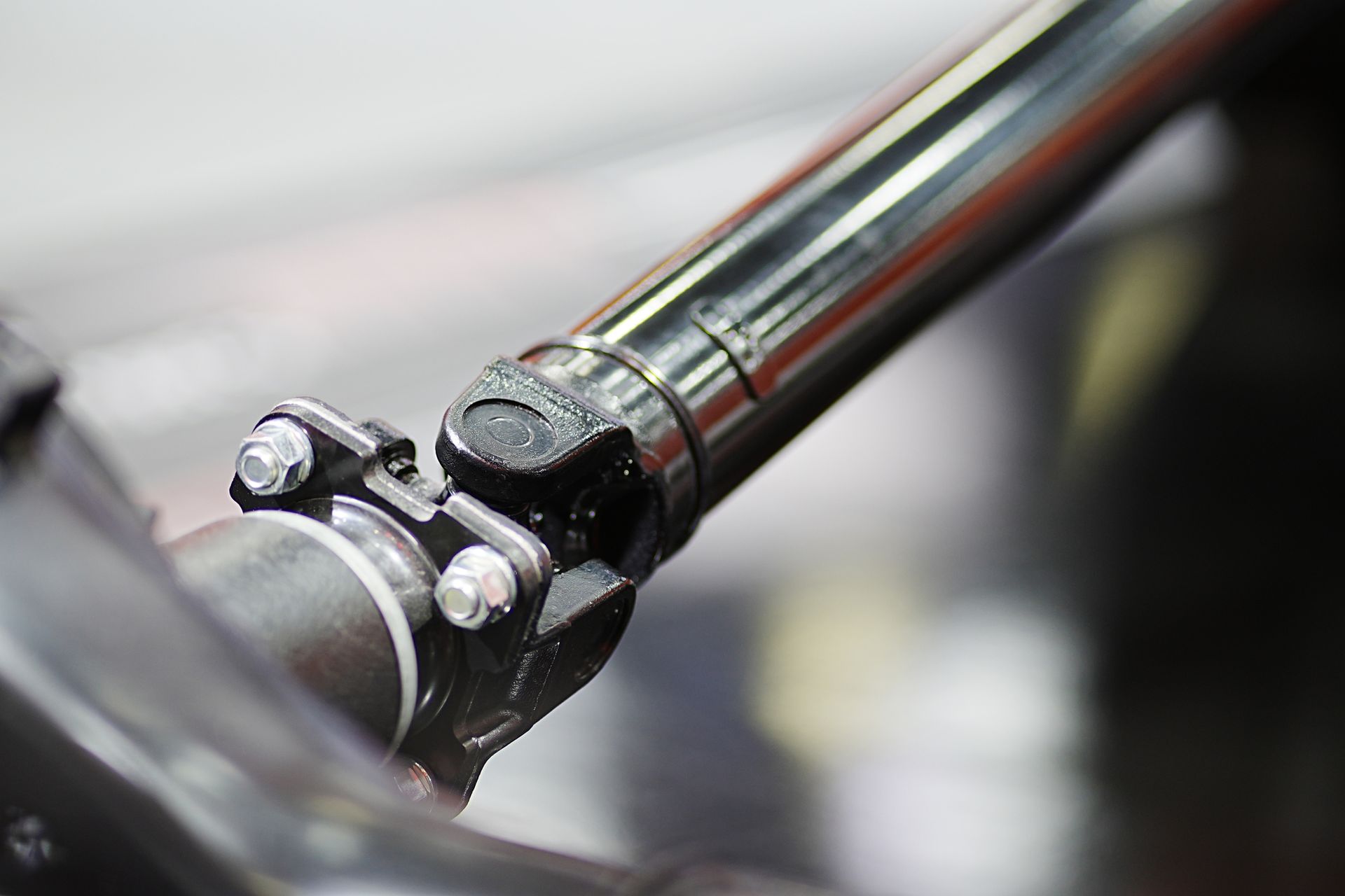 A close up of a drive shaft on a car. A close up of a drive shaft on a car.