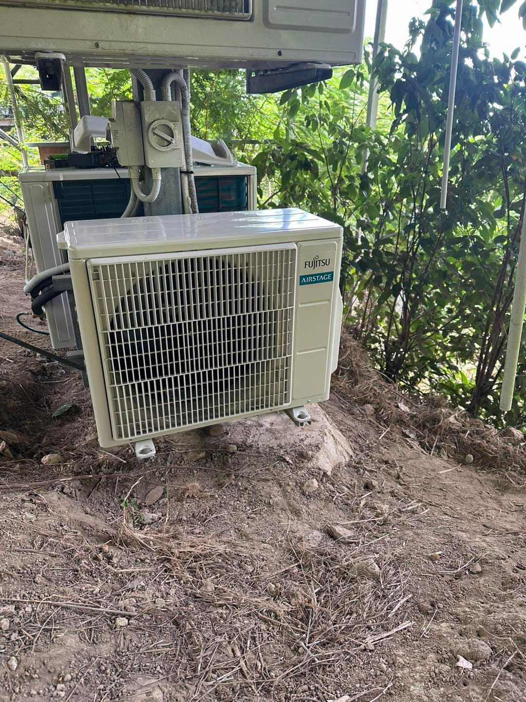 Outdoor Air Conditioning Unit on Dirt, With Others in Background — DJL Refrigeration & Air Conditioning In Airlie Beach, QLD
