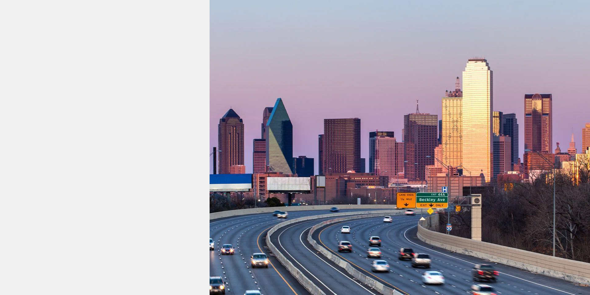 A highway with a city skyline in the background
