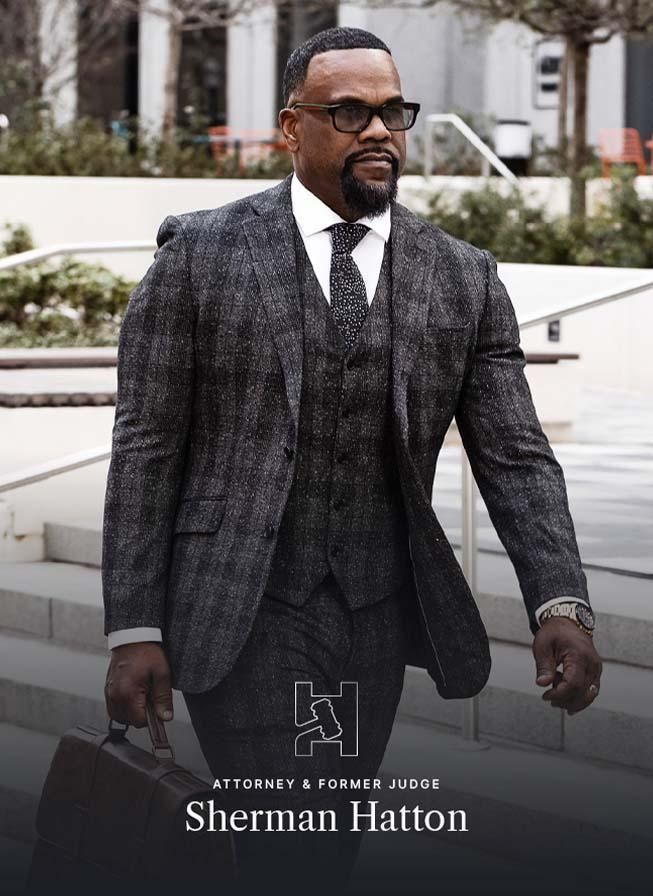 A man in a suit and tie is holding a briefcase.