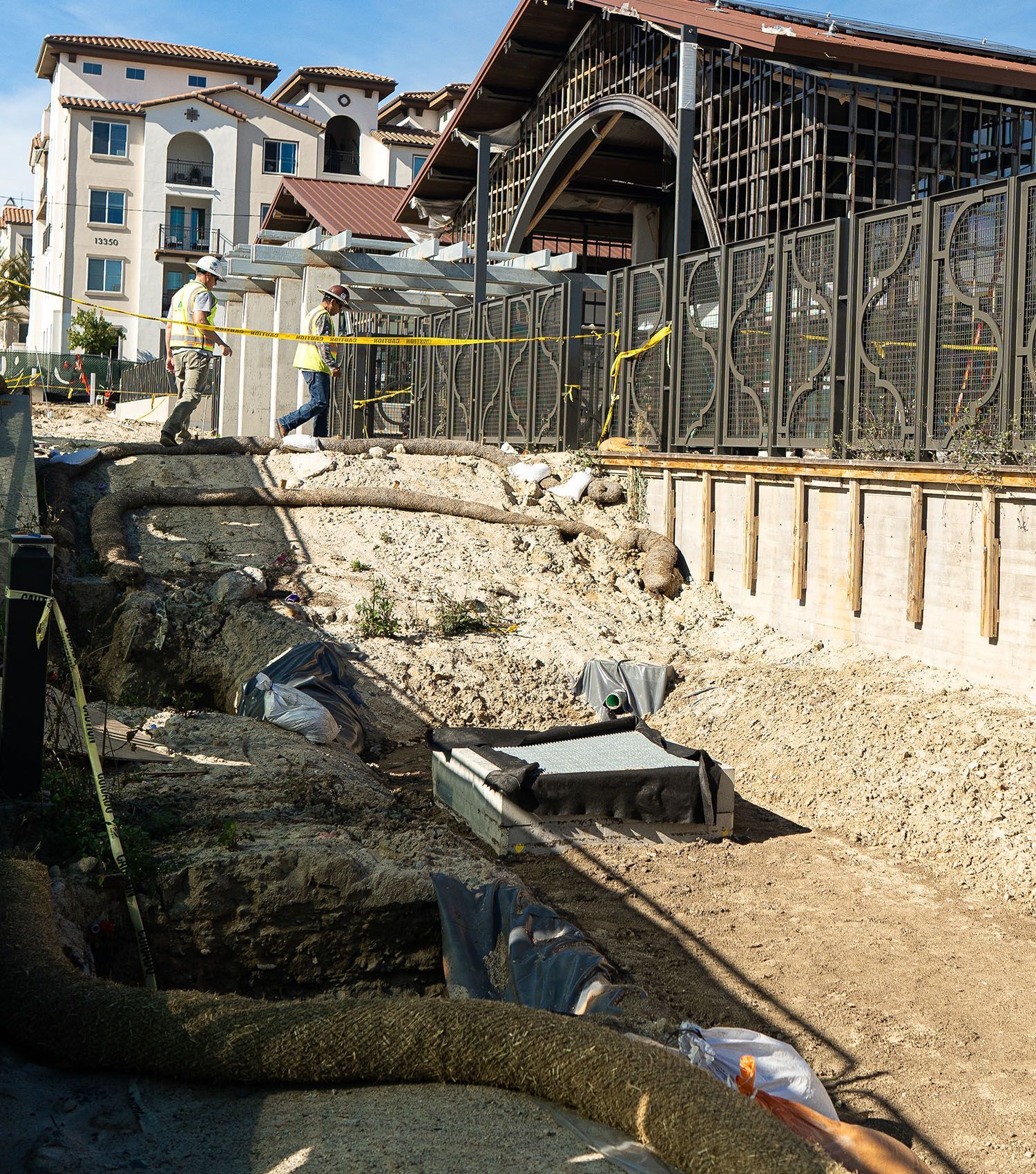 A construction site with a large building in the background