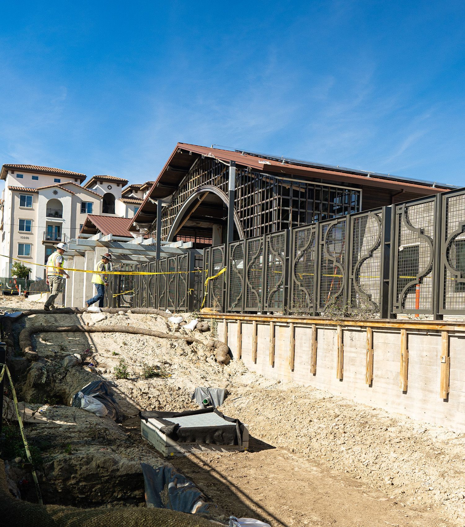 A construction site with a large building in the background.
