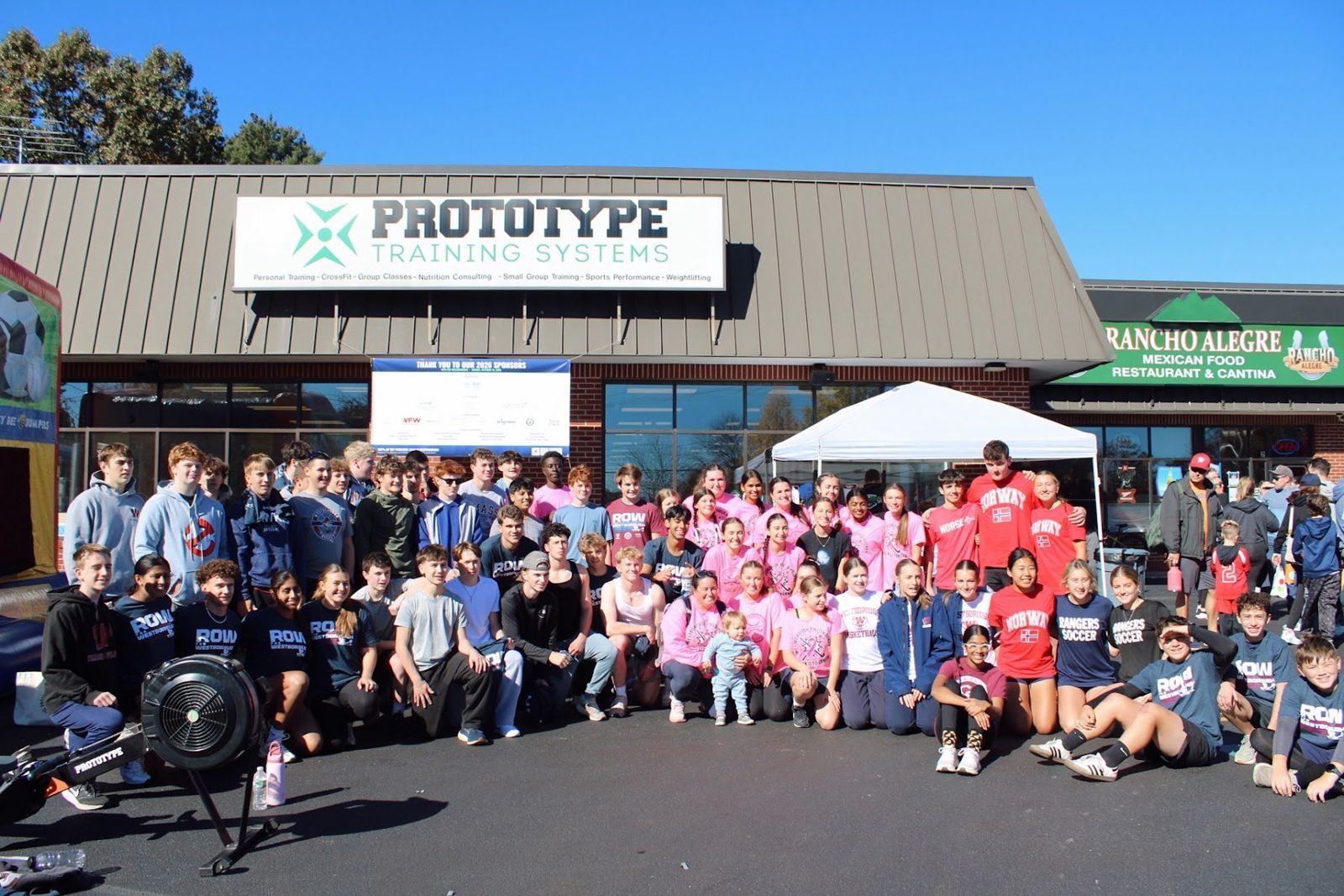 Westborough High School student-athletes in a big group photo in front of Prototype Training Systems on race day