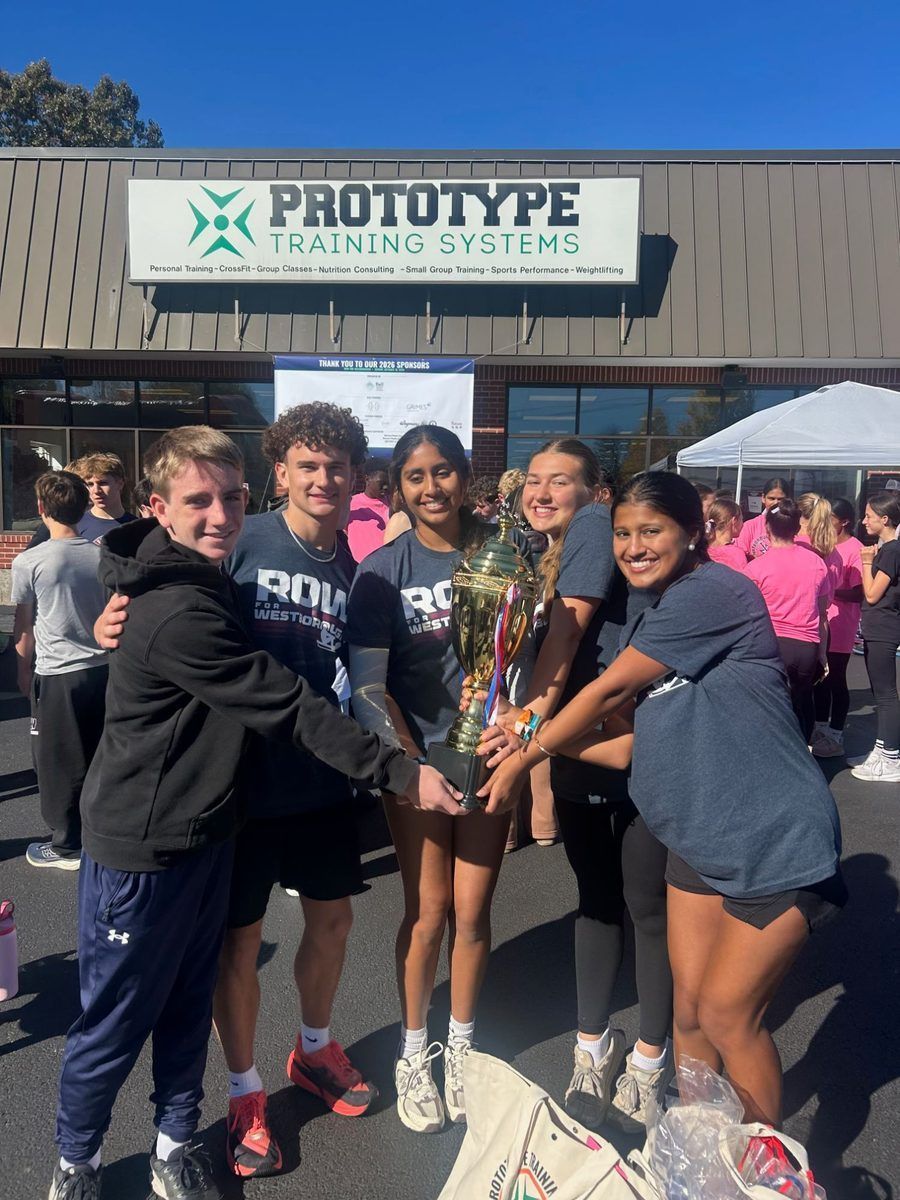 WHS Cross Country runners holding the top student fundraising trophy