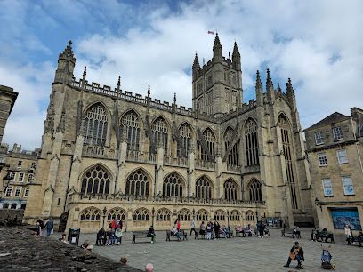 Bath Abbey, England, large Gothic church, people gathered outside on a plaza.