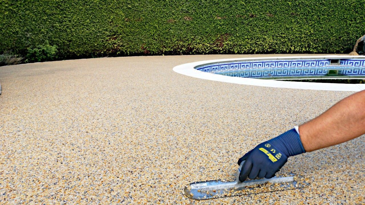 Resin patio around a swimming pool.