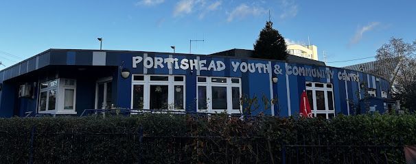 Portishead Youth & Community Centre, blue building with white text, set under a partly cloudy sky.