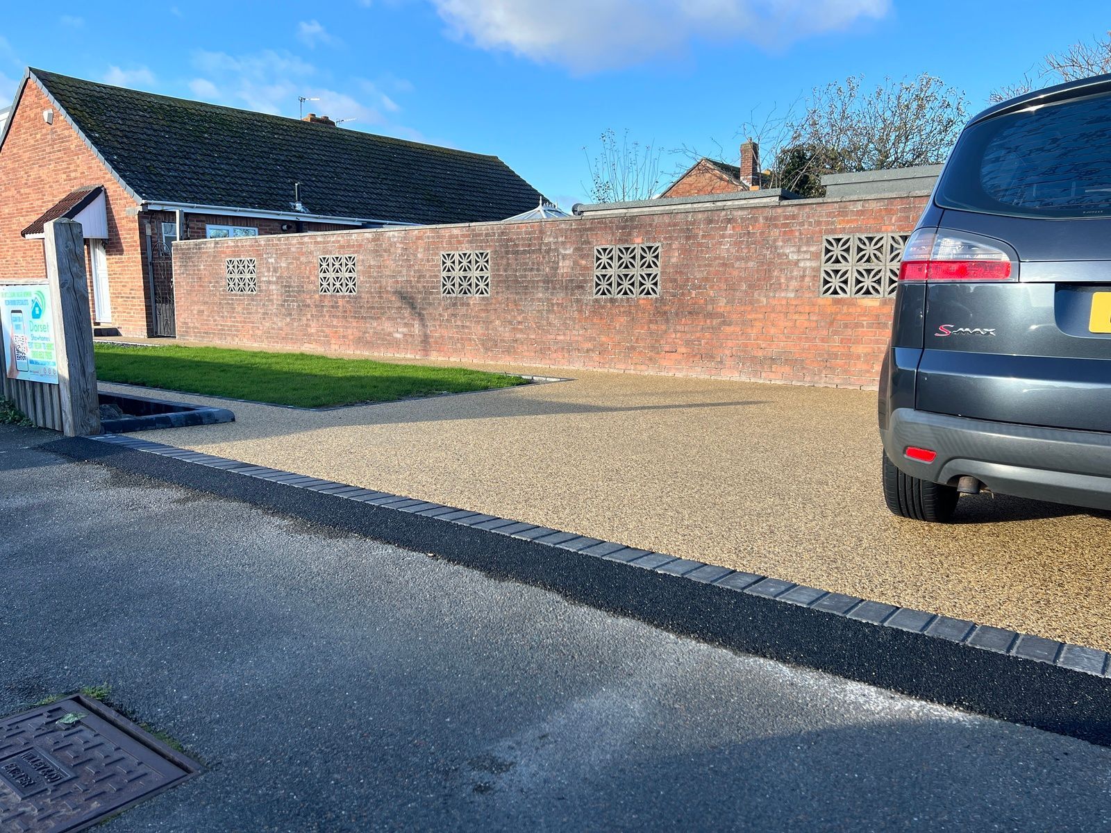 Gold resin driveway with black border.