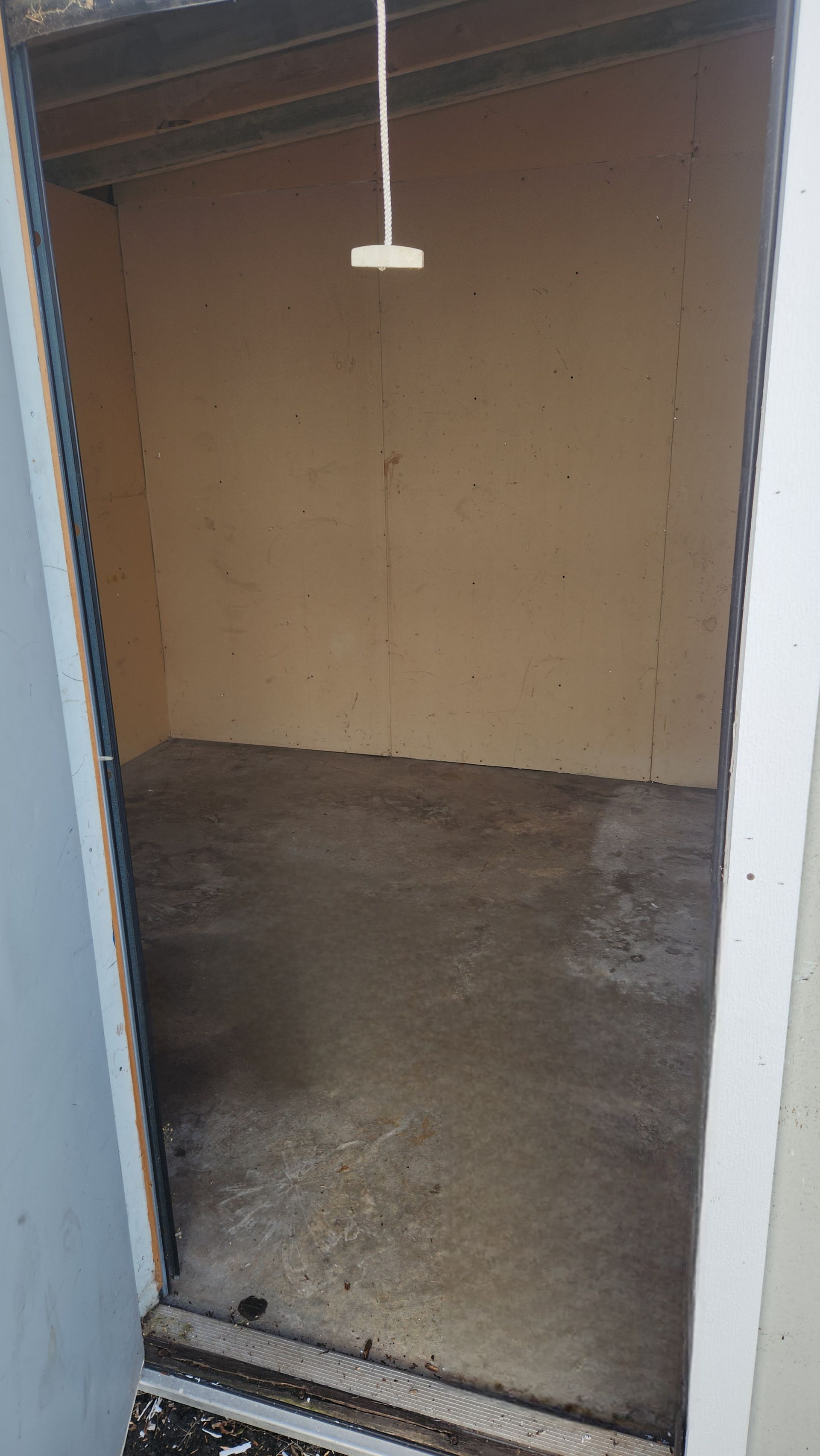 Empty storage unit with concrete floor and light tan walls. Empty storage unit with concrete floor and light tan walls.