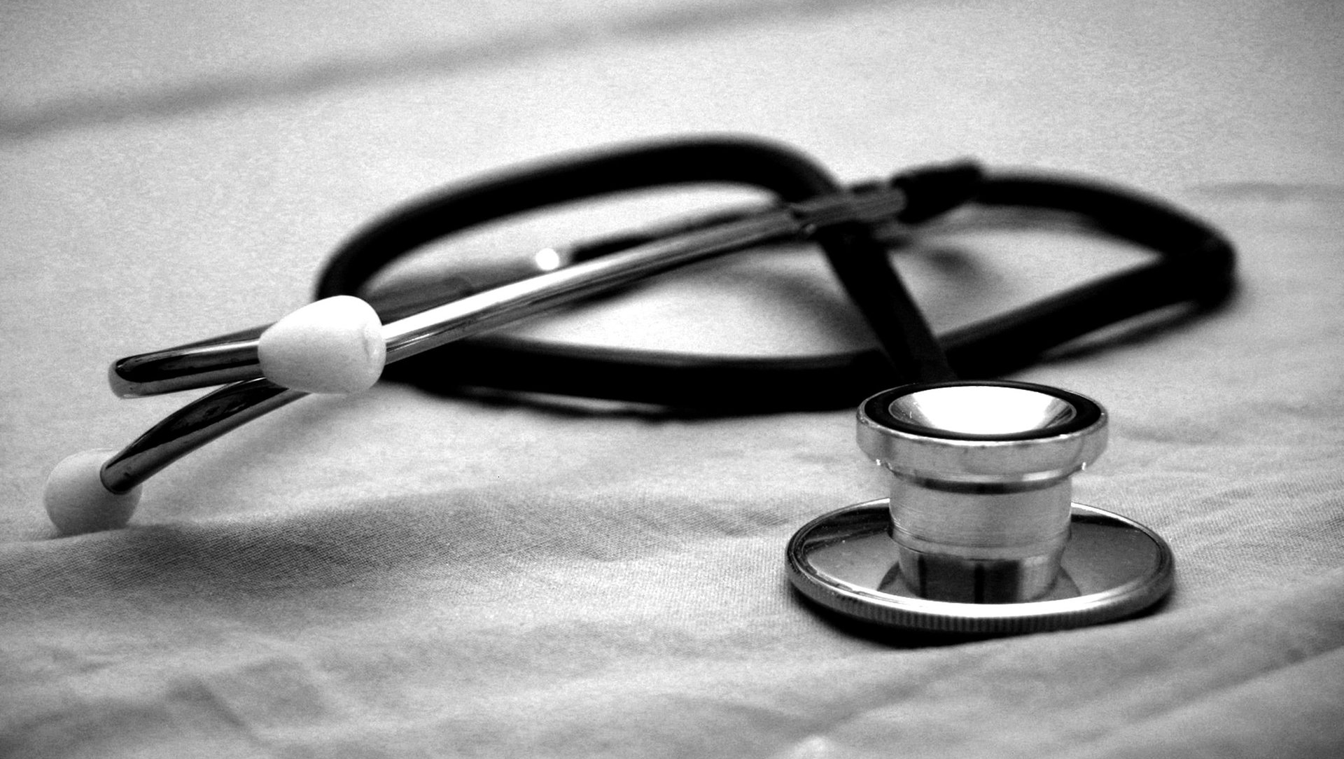 A black and white photo of a stethoscope on a table