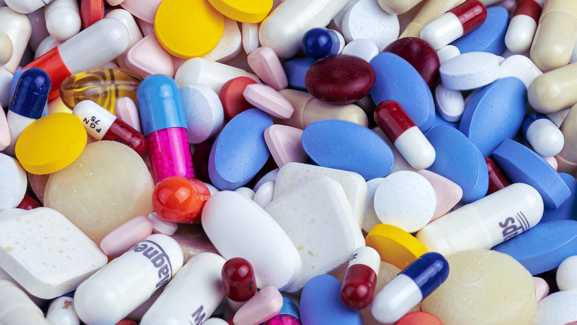 A pile of different types of pills and capsules