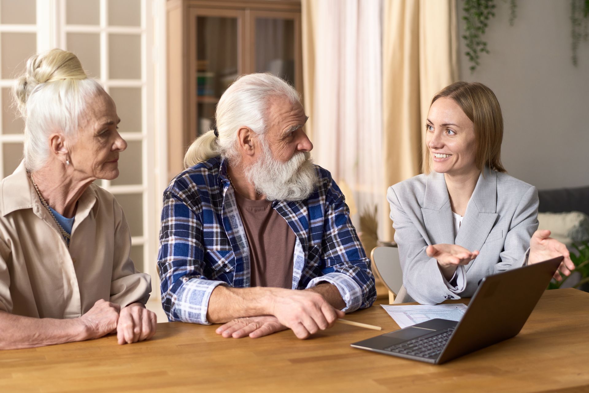 A woman talking to her elderly parents about health needs
