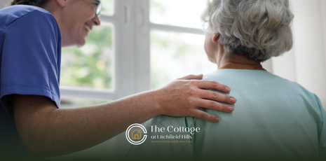 A caregiver tapping a senior's back